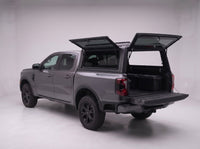 Rear door of the Ford Ranger truck cap lifted open with the tailgate down and storage totes in the bed