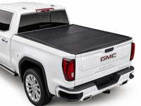 TruckTon hard flip-back tonneau cover closed on a GMC Sierra — low-profile matte black panels — view 1