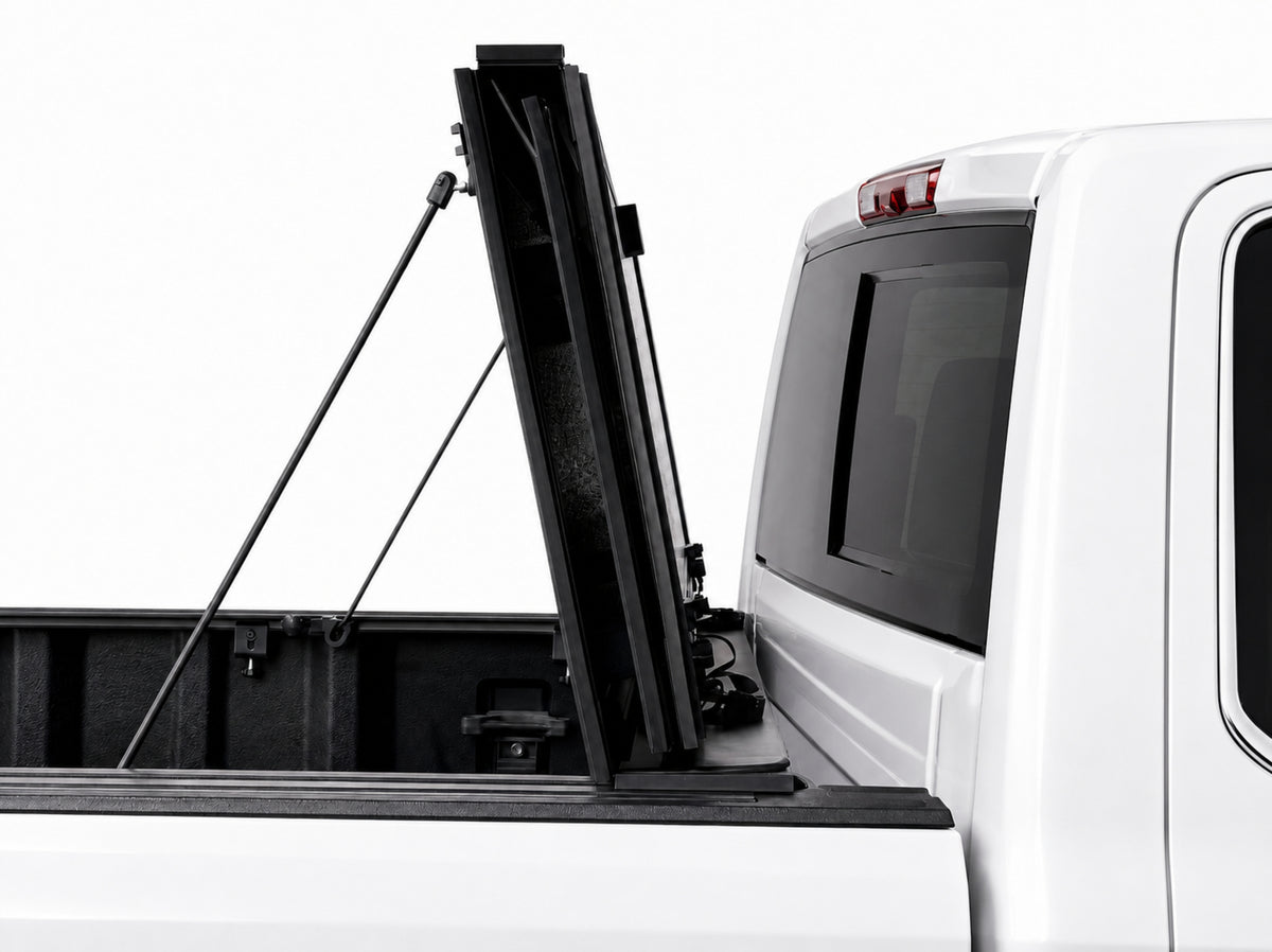 Cover folded fully upright against the cab, secured with prop rods