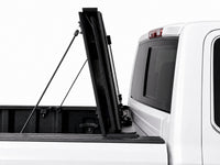 Cover folded fully upright against the cab with prop rods — GMC Sierra — view 12