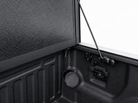 Latch mechanism, drain tube and prop rod detail inside the bed — view 17