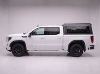 Side profile of a GMC Sierra 1500 fitted with the TruckTon aluminum truck cap with tinted windows