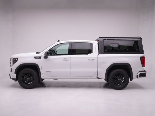 Side profile of the truck cap on a GMC Sierra 1500, following the cab lines