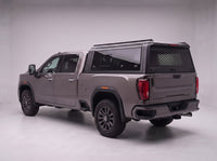GMC Sierra 2500HD 3500HD truck cap with the honeycomb security guard showing through the tinted rear window, studio view