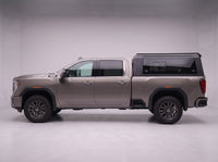Side profile of a GMC Sierra 2500HD 3500HD fitted with the TruckTon aluminum truck cap with tinted windows