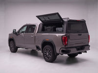 Lift-up side window open on the GMC Sierra 2500HD 3500HD truck cap, giving access to tool cases in the bed from beside the truck