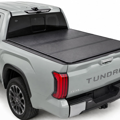 TruckTon low-profile hard tri-fold tonneau cover closed on a Toyota