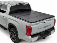 TruckTon low-profile hard tri-fold tonneau cover closed on a Toyota — view 1