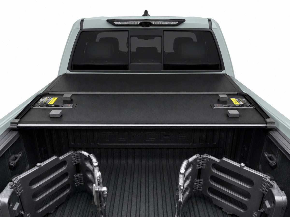 Folded cover viewed from inside the truck bed — clamp-on rails