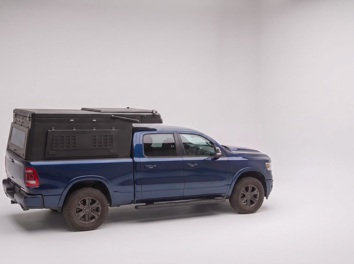 Step 1, closed for driving: the Double Pop-Up truck cap camper packed flat on a Ram 1500