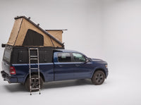 Studio side view of the Double Pop-Up truck cap camper on a Ram 1500