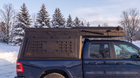 Ram 1500 truck cap camper closed up for winter driving on a snowy Ontario road