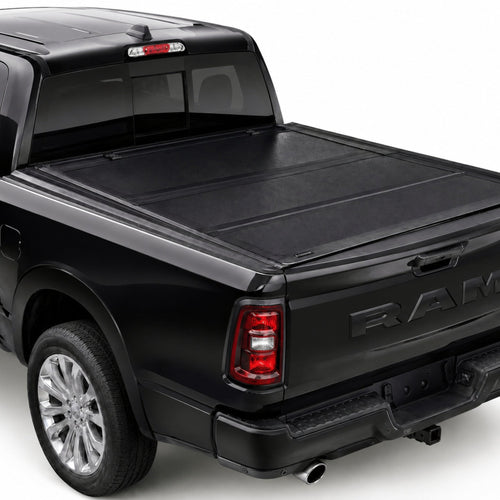 TruckTon hard flip-back tonneau cover closed on a RAM 1500 — low-profile matte black panels