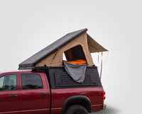 Studio side view of the Single Pop-Up truck cap camper on a Dodge Ram 2500/3500