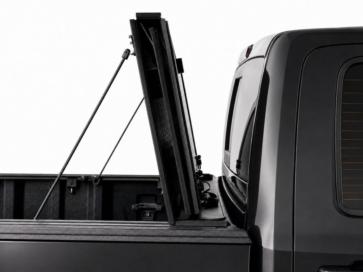 Cover folded fully upright against the cab, secured with prop rods