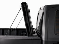 Cover folded fully upright against the cab with prop rods — RAM 1500 — view 12