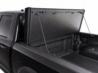 Propped-open panel showing gas struts and bed access — RAM 1500 — view 16