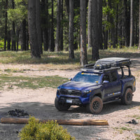 Front view of a Tacoma with the M'LinkX roof rack at camp — view 7