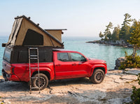 Toyota Tacoma Double Pop-Up truck cap camper with the roof tent open on the Georgian Bay shoreline in Ontario