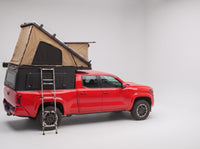 Studio side view of the Double Pop-Up truck cap camper on a Toyota Tacoma