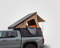 Studio side view of the Single Pop-Up truck cap camper on a Toyota Tacoma