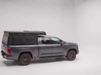 Step 1, closed for driving: the Double Pop-Up truck cap camper packed flat on a Toyota Tundra