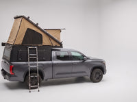 Studio side view of the Double Pop-Up truck cap camper on a Toyota Tundra