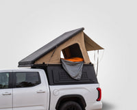 Studio side view of the Single Pop-Up truck cap camper on a Toyota Tundra