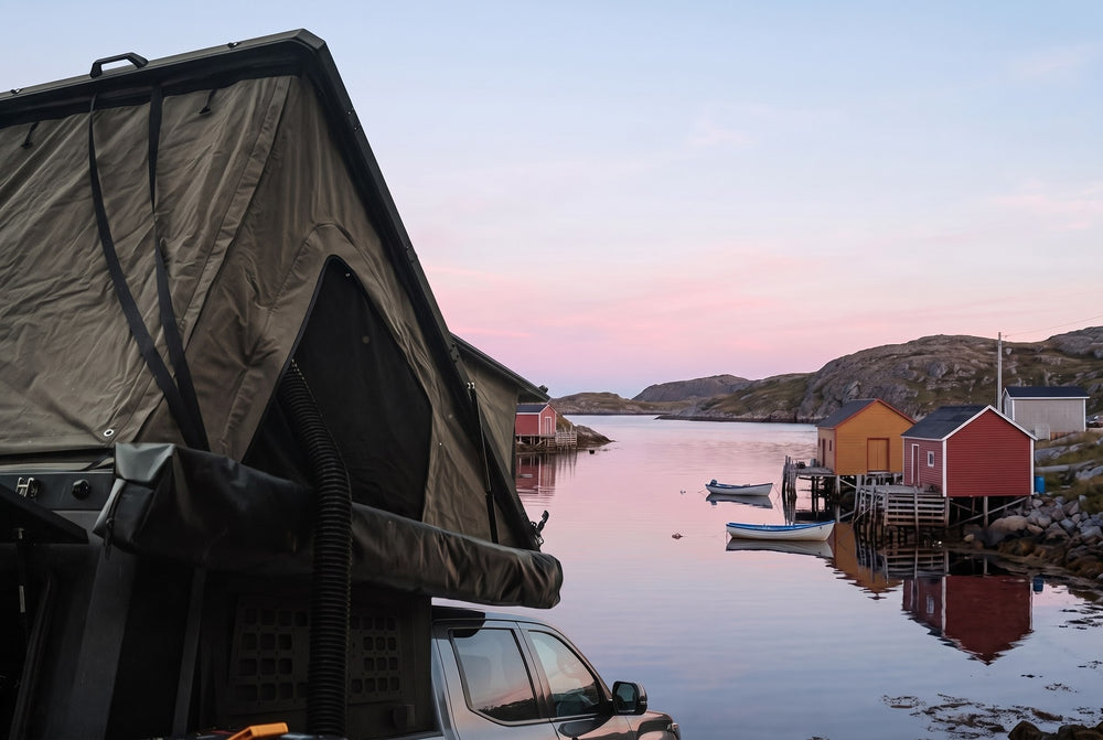 Side of the open roof tent on a Toyota Tundra, overlooking a Newfoundland fishing cove at dawn (the side awning shown is not included)