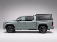 Side profile of a Toyota Tundra fitted with the TruckTon aluminum truck cap with tinted windows