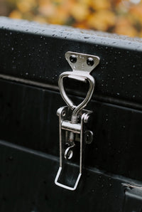 Stainless steel draw latch on the matte black powder-coated aluminium camper body