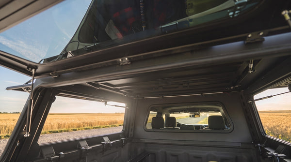Interior pass-through from the truck cap up into the roof tent