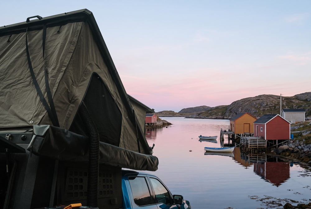 Side of the open roof tent overlooking a Newfoundland fishing cove at dawn (the side awning shown is not included)