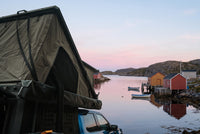 Side of the open roof tent overlooking a Newfoundland fishing cove at dawn (the side awning shown is not included)