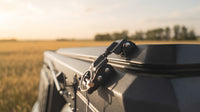 Stainless draw latch with locking pin on the matte black truck cap camper roof